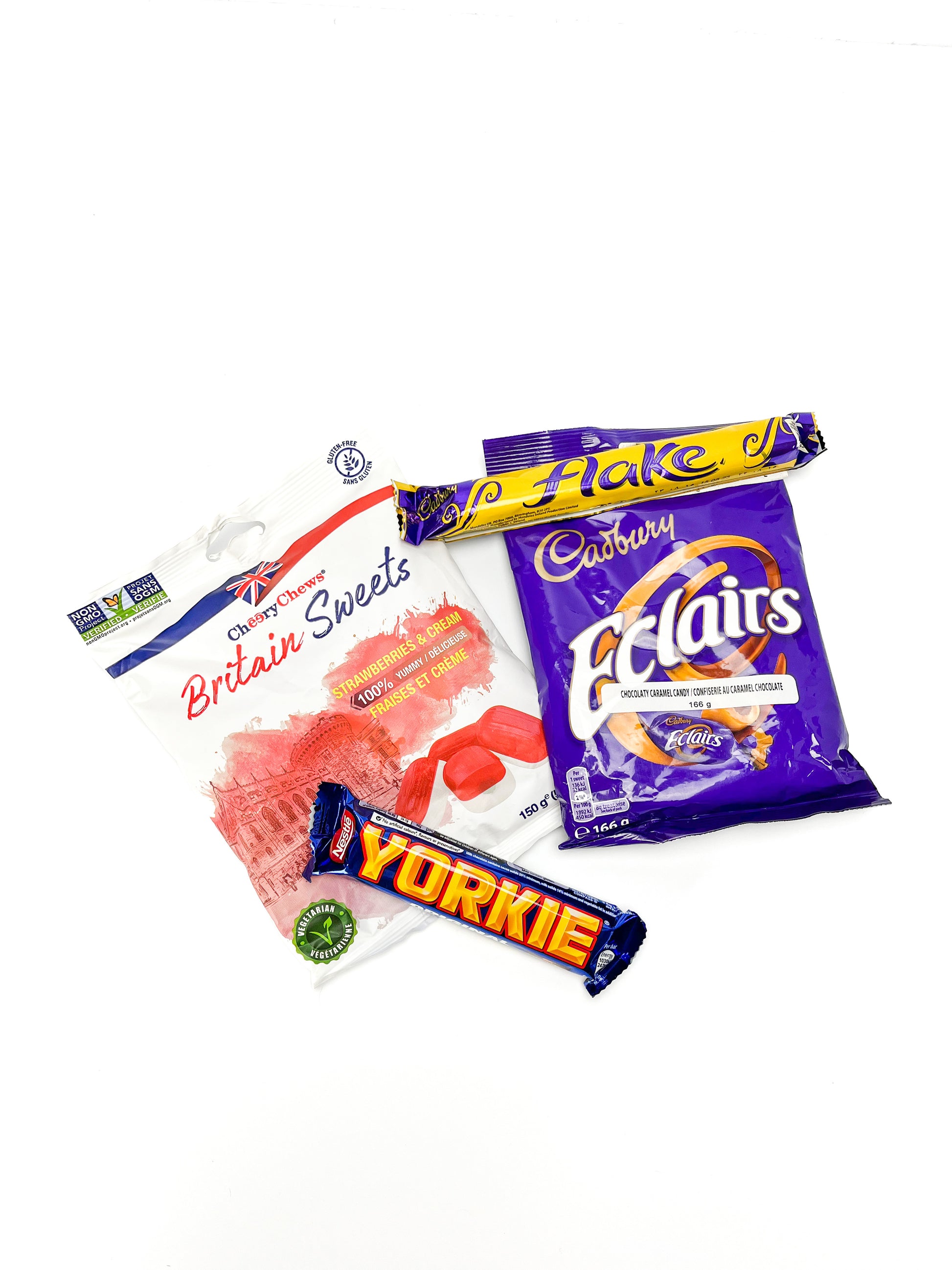 A package of britain sweets, cadbury eclaires, flake chocolate bar, and a yorkie bar displayed on a white background.